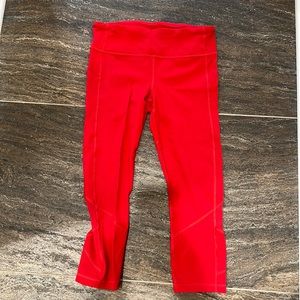 Red Lululemon running tights with side pockets and zip back